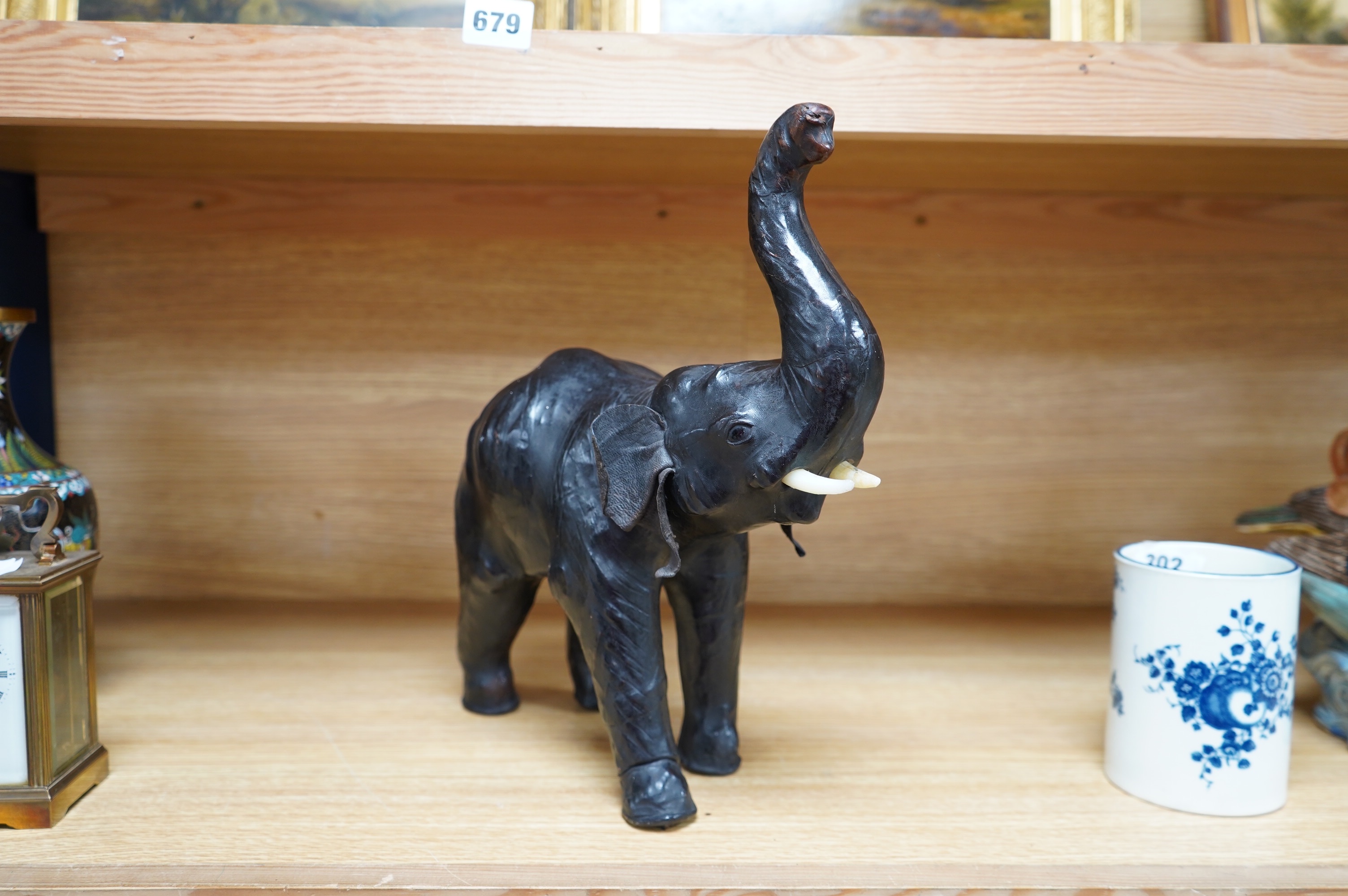 A small leather covered model of an elephant, stamped Liberty, 31cm. Condition - fair